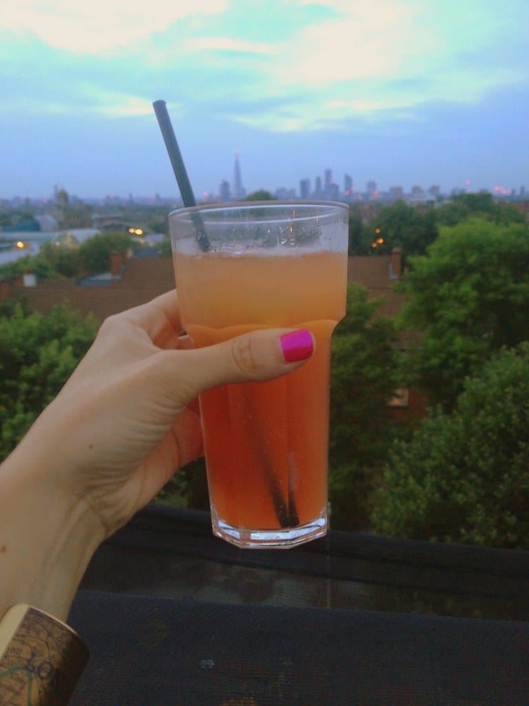 Moody cocktail on a bar counter at night, evoking a rooftop mezcal bar atmosphere
